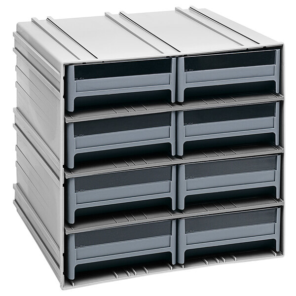 A stack of grey Quantum storage drawers with black handles.
