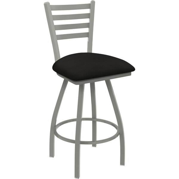 A black bar stool with a brown seat.