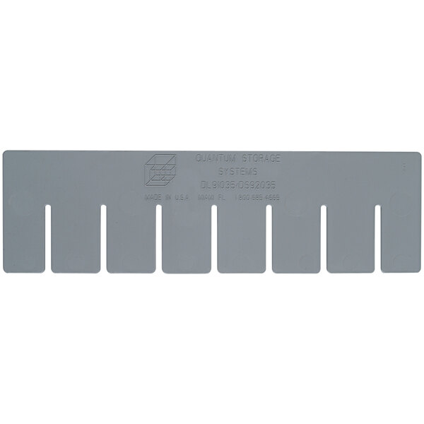 A grey plastic long divider with text and five holes.