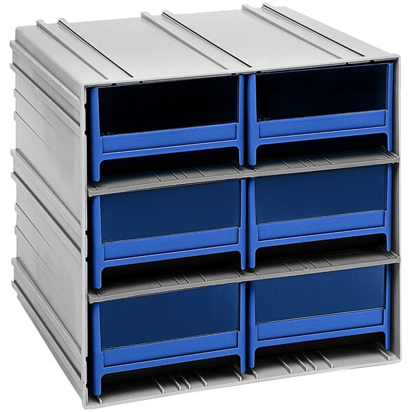 A stack of blue plastic drawers on a white shelf.