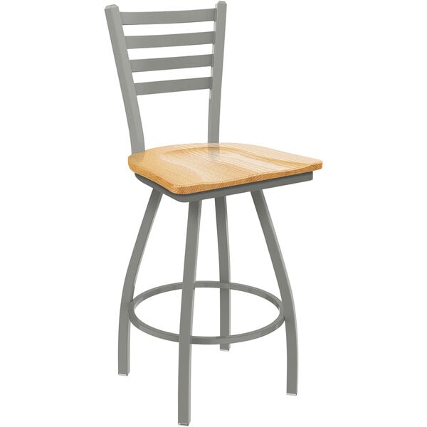 A Holland Bar Stool Jackie ladderback swivel counter stool with a natural oak seat and an anodized nickel finish.