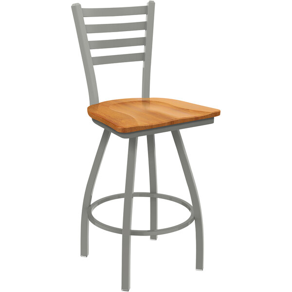 A Holland Bar Stool Jackie ladderback swivel counter stool with a medium maple seat and an anodized nickel finish.