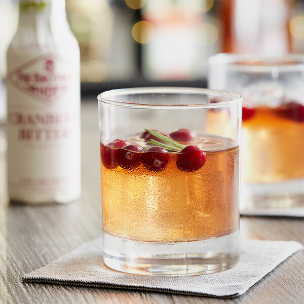 A glass of cranberry cocktail with Fee Brothers Cranberry Bitters.