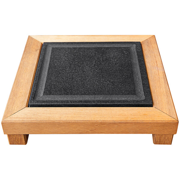 A black rectangular granite slab in a wooden frame.