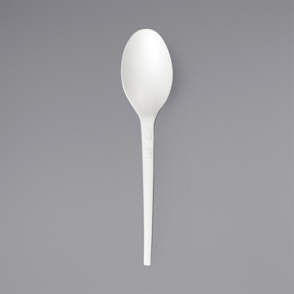 A close up of a Solia white plastic teaspoon.