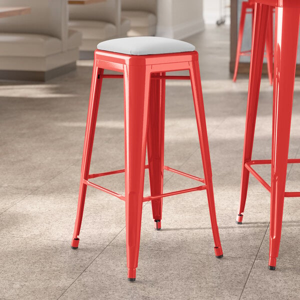 Lancaster Table & Seating Alloy Series Ruby Red Indoor Backless Barstool with White Vinyl Cushion