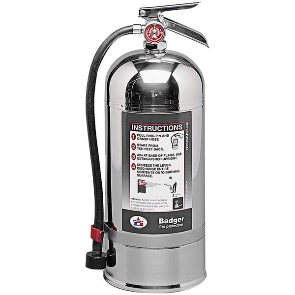 A silver Badger Class K fire extinguisher with a red and black label and hose.
