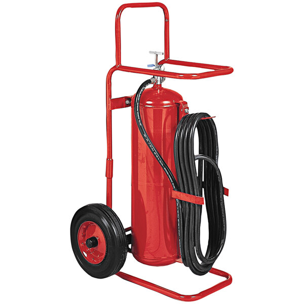 A red fire extinguisher on wheels with a black hose.