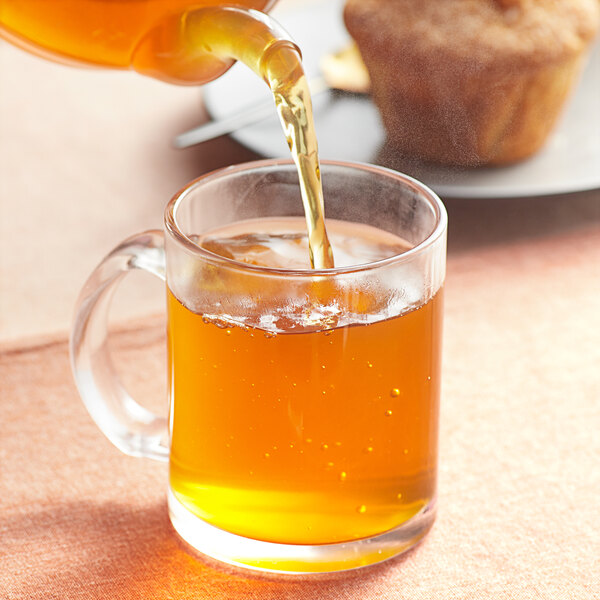 Davidson's Organic Mao Jian Jasmine Loose Leaf Tea being poured into a glass cup.