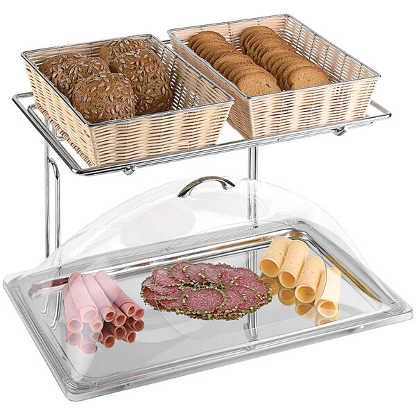 A APS two-tier buffet frame holding trays of food on a counter.