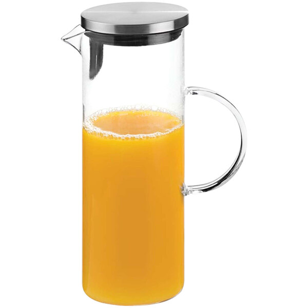 An APS glass carafe filled with orange juice.