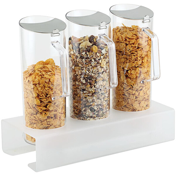 An APS cereal bar with three glass containers full of cereal.