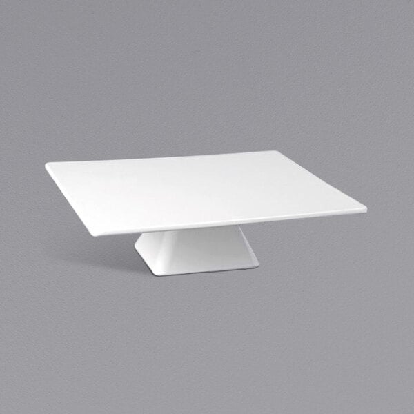 A white square short melamine cake stand with a square base.