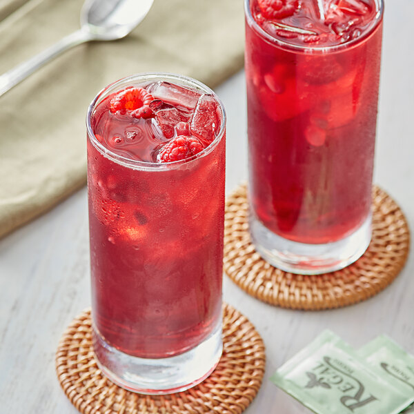 Two glasses of Davidson's Organic Pomegranate Berry Iced Tea with ice and mint.