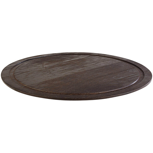 An APS Expresso wood cake tray with a black rim on a round wooden surface.