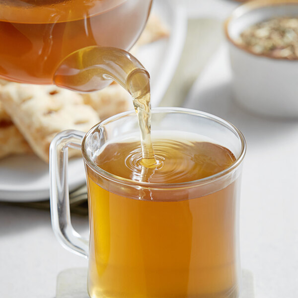 Davidson's Organic Tulsi Ginger Lemon Tea being poured into a glass.