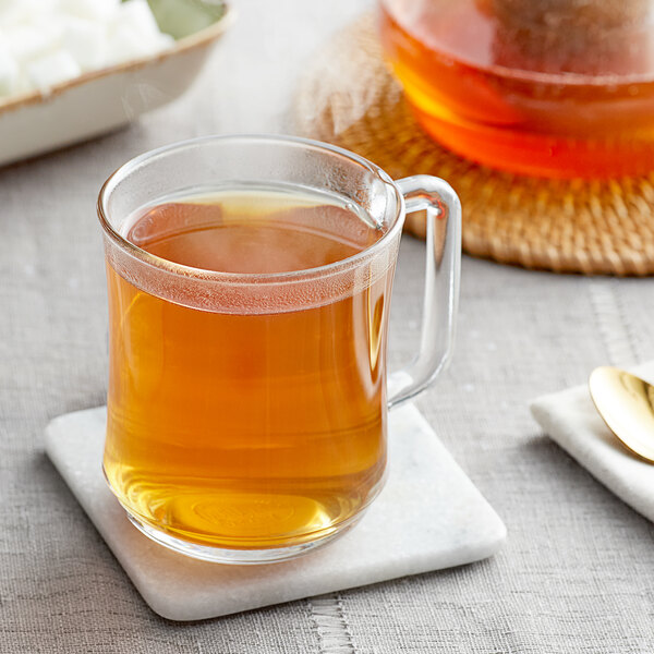 A glass mug of brown Davidson's Organic Ginger Chai Tea.