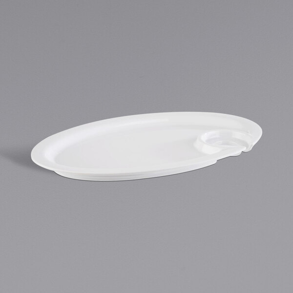 A white oval melamine plate with a glass holder on it.