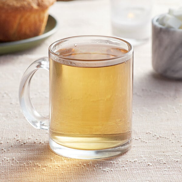 A glass mug of brown Davidson's Organic Lavender Petals tea sits on a table.