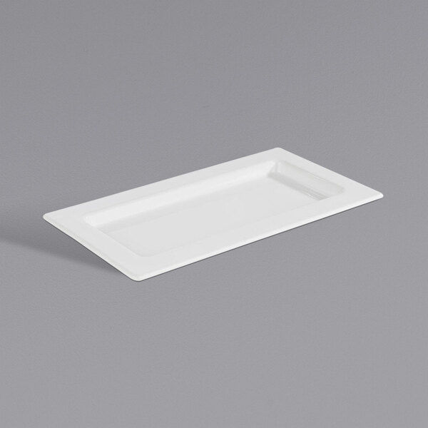 A white rectangular APS porcelain tray with a handle.