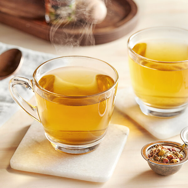 Two glass cups of Davidson's Organic Tulsi Rose Petals tea with steam and spices.