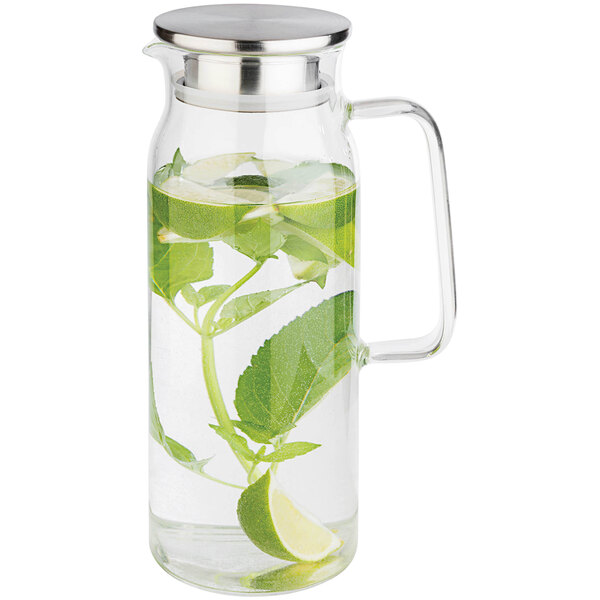 An APS glass carafe with water and limes.