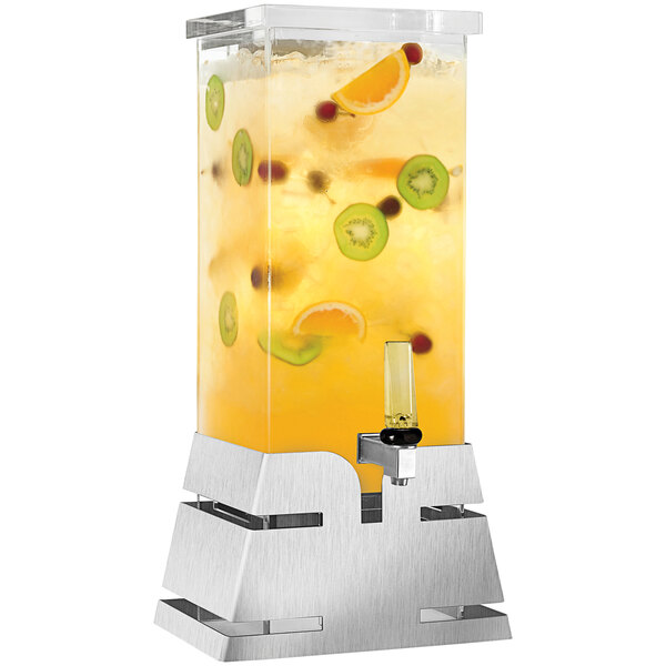 A Rosseto clear plastic beverage dispenser with fruit in it on a stainless steel base.