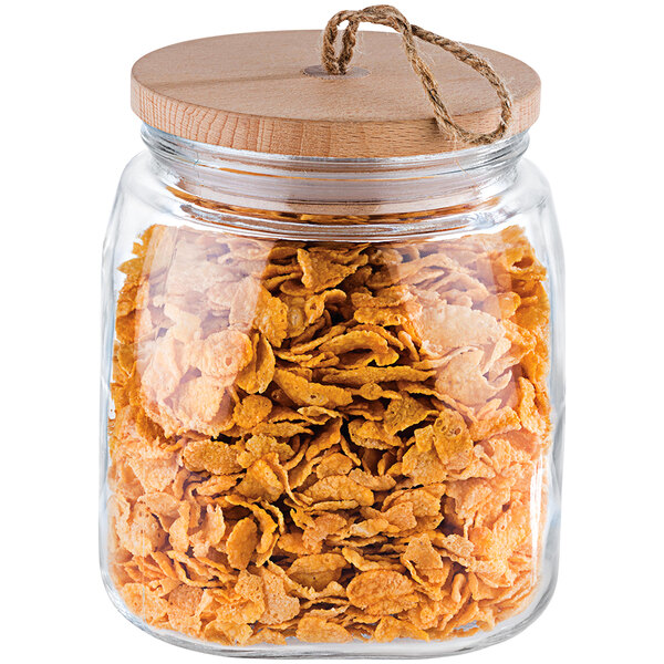 An APS Woody square glass jar filled with cereal and a wood lid.