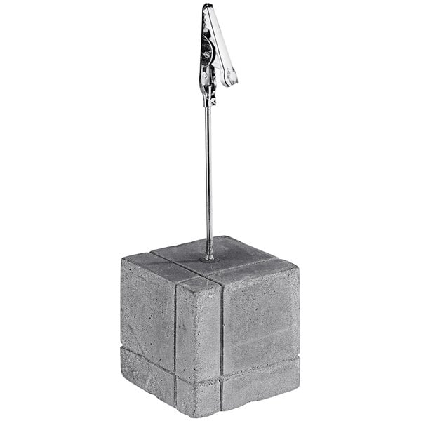 A concrete block with a metal clip.