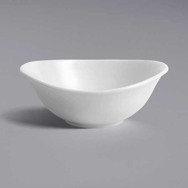 A close-up of a Dudson Organic White deep coupe bowl with a curved edge.