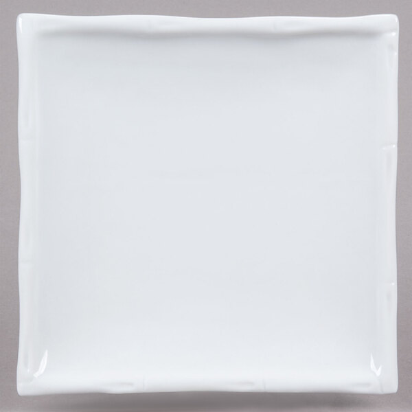A CAC white square porcelain plate with a white edge.