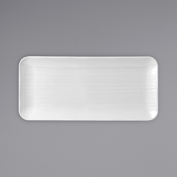 A white rectangular Dudson china plate on a gray background.