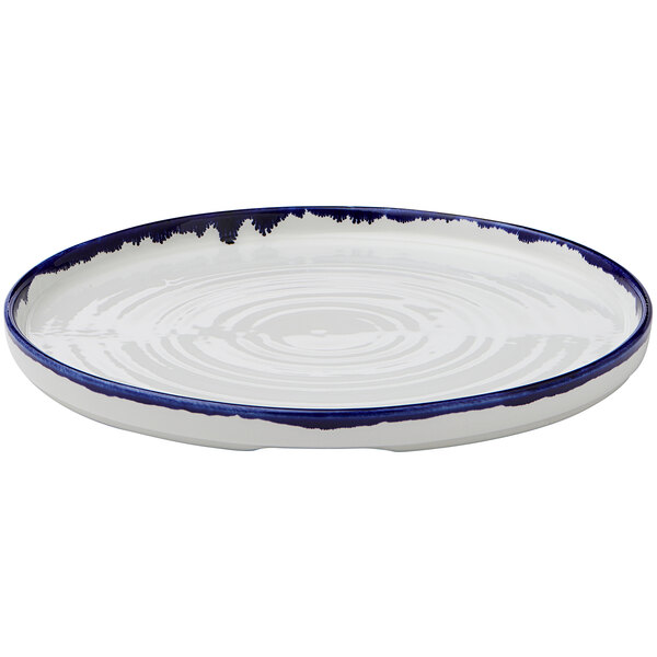 A white Dudson Harvest china plate with a blue rim.