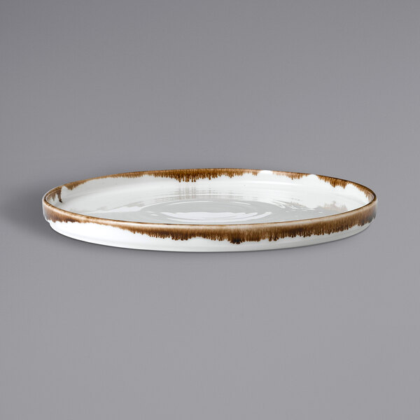 A white china plate with a brown rim.
