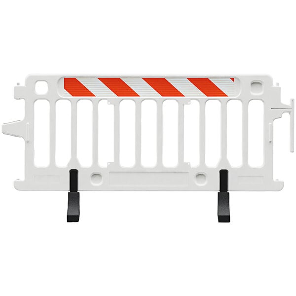 A close-up of a white and orange Plasticade Crowdcade parade barricade with white and orange striped sheeting on one side.