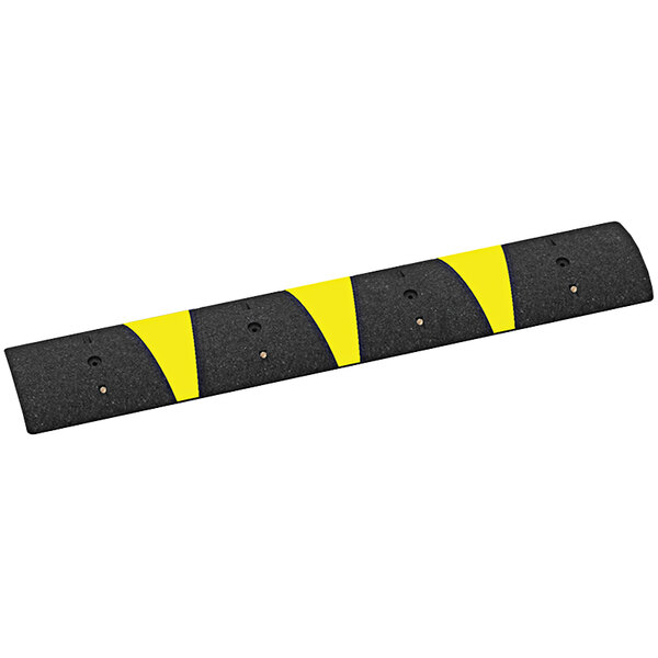 A black Plasticade speed bump with yellow reflective stripes.