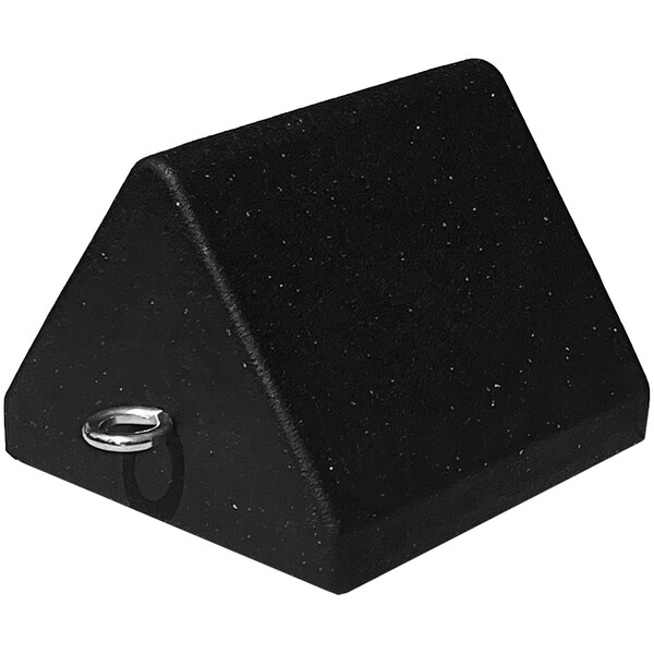 A black triangle-shaped rubber wheel chock with a metal ring.