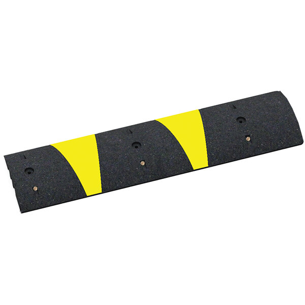 A black rubber speed bump with yellow reflective stripes.