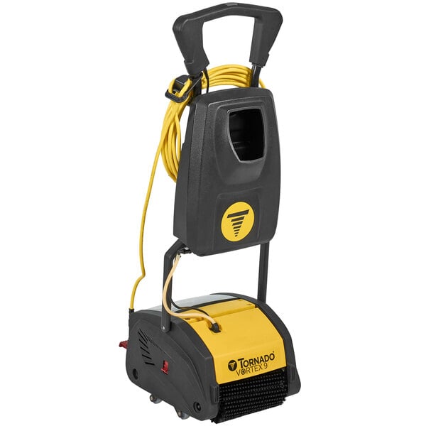 A black and yellow Tornado Vortex walk behind cylindrical floor scrubber with a yellow cord.