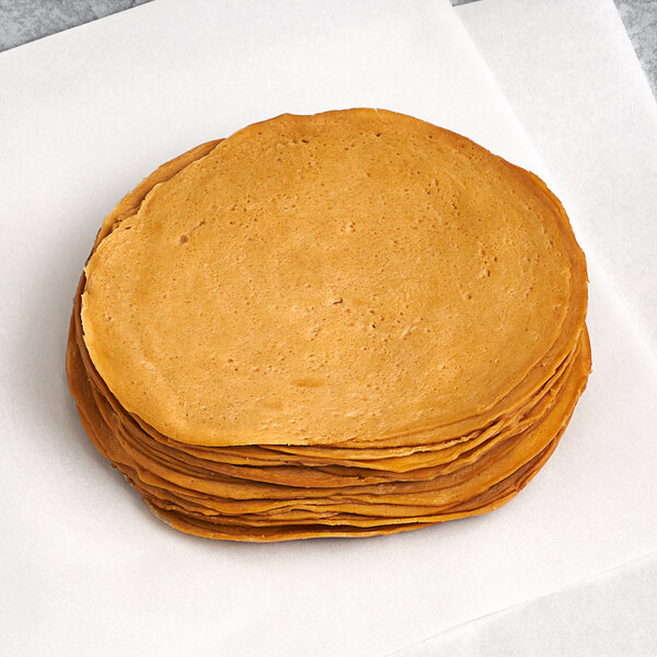 A stack of Tofurky Vegan Oven Roasted Turk'y Deli Slices on a white surface.