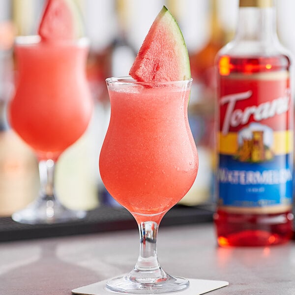 A glass of watermelon Torani flavoring syrup in a drink.