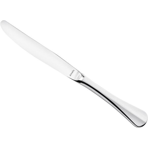 An Amefa stainless steel table knife with a white handle.