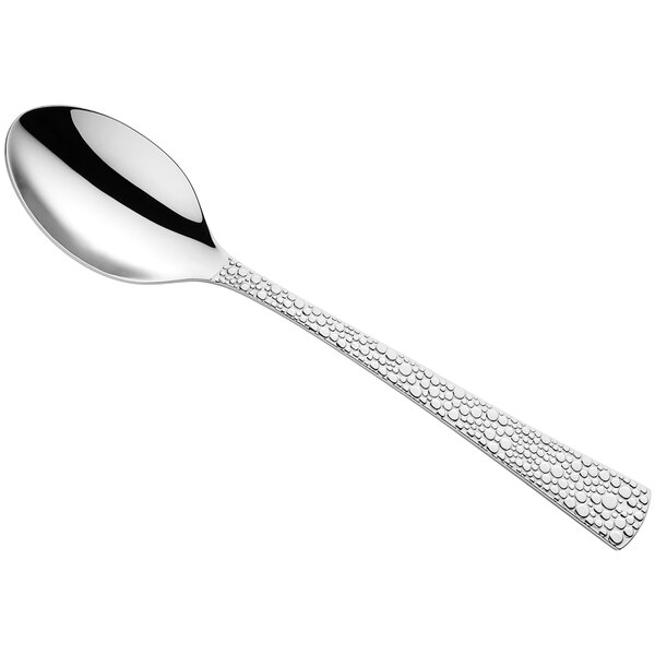 An Amefa Livia Ronda stainless steel serving spoon with a silver handle and a design on the spoon bowl.