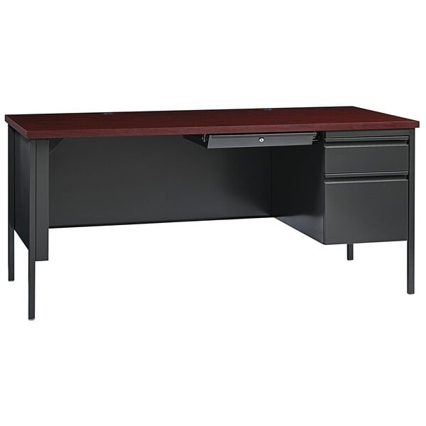 A charcoal desk with mahogany drawer and pedestal.