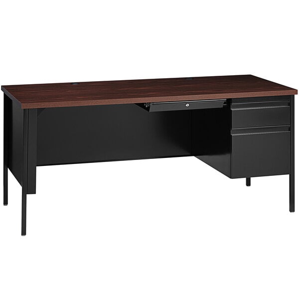 A black Hirsh Industries office desk with a wooden top and a center drawer.
