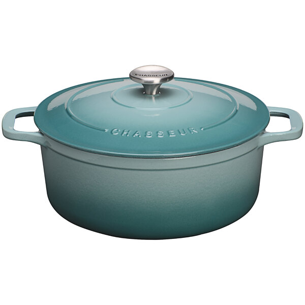 A turquoise Chasseur enameled cast iron Dutch oven with a lid.