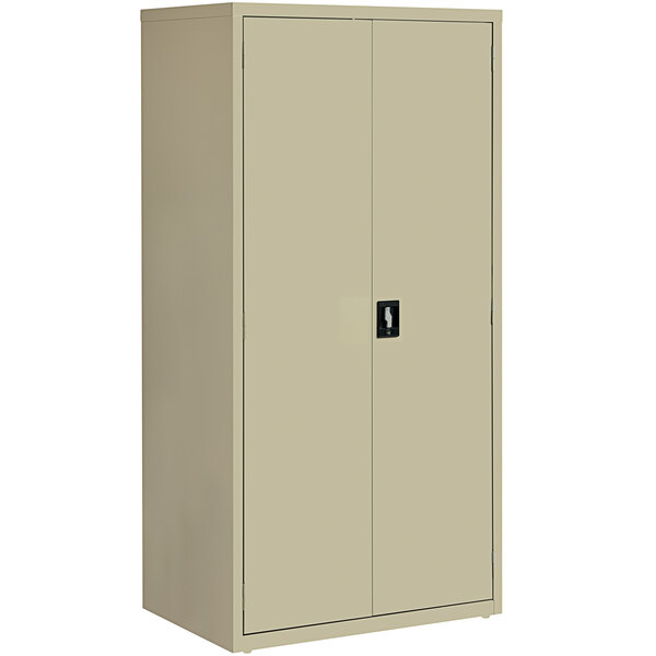 A tan metal storage cabinet with black handles and two doors.