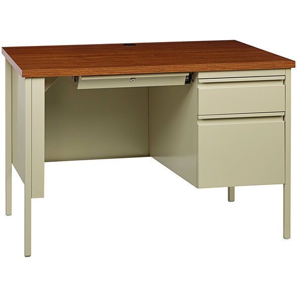 A Hirsh Industries office desk with a wooden top and a right-hand pedestal with drawers.