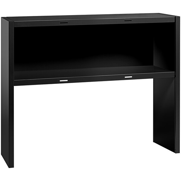 A black desk with a shelf over it.