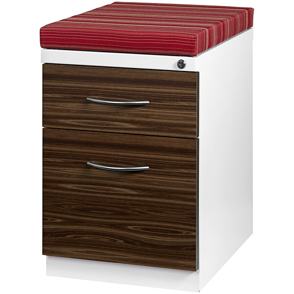 A white Hirsh Industries mobile pedestal filing cabinet with a red cushion on top.